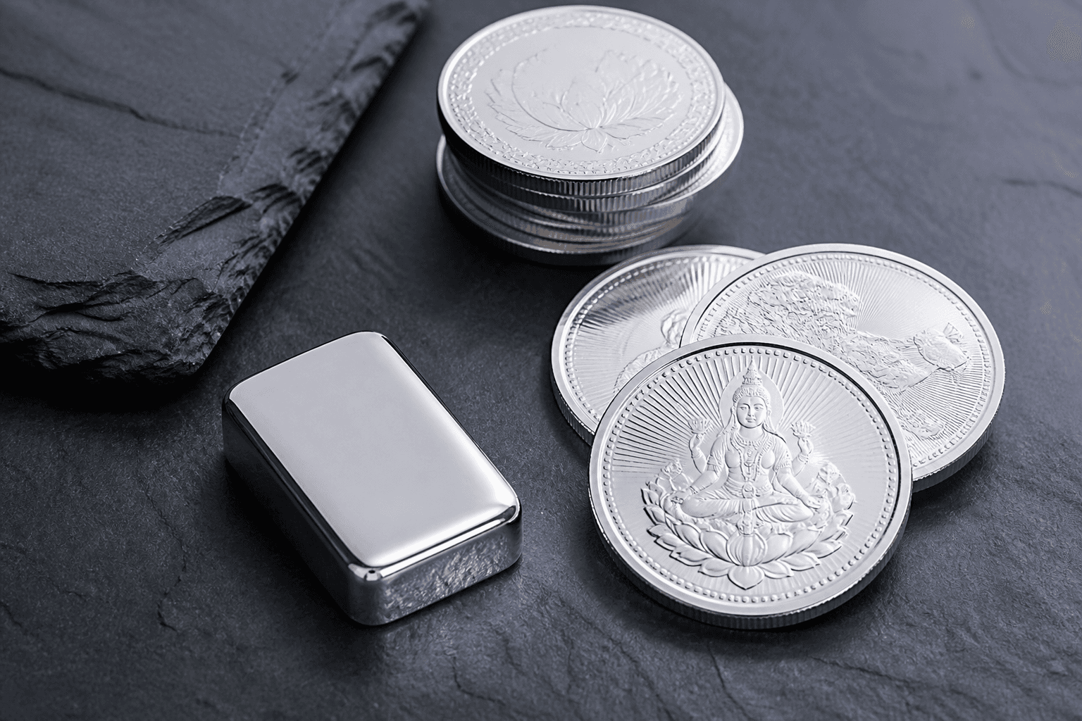 polished silver coins and a small bar on dark slate — Silver Investment Guide for Beginners in India
